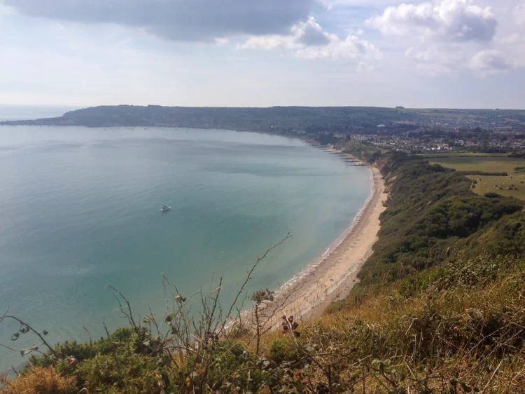 Swanage Bay - a curving sandy beach seen from the cliffs above