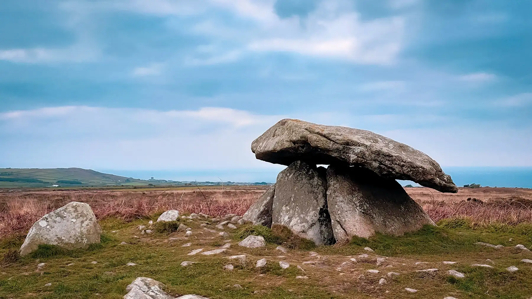 Chun Quoit, an ancient arrangement of supporting stones with a large slab on top, is an impressive sight in this remote and desolate landscape with the Atlantic ocean as a backdrop.